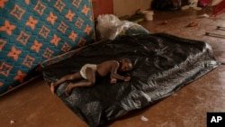 A child sleeps at the Lycée des Lumières where he received asylum, in Mamoudzou, Mayotte, December 19, 2024.