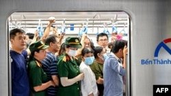 People board a HCMC Metro Line 1 train at a subway station in Ho Chi Minh City on December 22, 2024.