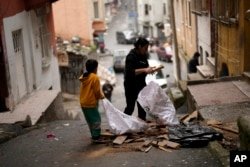 Residents collect pieces of wood to burn for warmth in the Tarlabasi neighborhood of Istanbul, Türkiye on December 4, 2024.