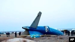 In this photo taken from a video released by the administration of the Mangystau region, a part of an Azerbaijan Airlines Embraer 190 lies on the ground near Aktau Airport in Kazakhstan on Dec. 26, 2024.