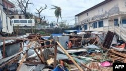 This photo shows piles of metal sheets and wooden debris in the capital Mamoudzou after Cyclone Chido struck Mayotte, in the Indian Ocean region of France, on December 14, 2024.