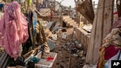 A young girl walks in the Kaweni slum on the outskirts of Mamoudzou in Mayotte island in the French Indian Ocean, after Cyclone Chido on December 19, 2024.