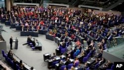 FILE - German Chancellor Olaf Scholz speaks during a plenary session in the Bundestag, the German parliament where he faces a vote of confidence, Berlin, Germany, Dec. 16, 2024.