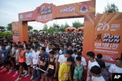 Participants prepare for the start of a 5km race event called 'Run for Life, Tsunami Memorial 2024' to commemorate the 20th anniversary of the Indian Ocean tsunami in Banda Aceh, Aceh Province, Indonesia on December 15, 2024.