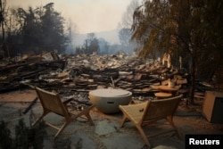 Debris covered furniture is seen on the ground in the Pacific Palisades neighborhood on the west side of Los Angeles on January 9, 2025.