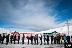 FILE - Voters line up to cast their ballots for parliamentary elections at a polling station in Nuuk, the capital of Greenland, on April 6, 2021. Another general election is scheduled to be held in Greenland by April 2025.